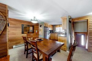 a kitchen with a wooden table and a dining room at Okemo Village B5 in Ludlow