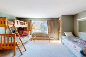 a bedroom with two bunk beds and a window at Okemo Village B5 in Ludlow