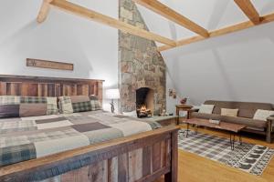 a bedroom with a large bed and a fireplace at Gondola Lodge in Killington