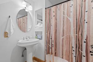 a bathroom with a sink and a shower curtain at Gondola Lodge in Killington +125 photos