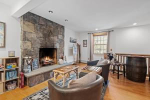 a living room with a large stone fireplace at Gondola Lodge in Killington