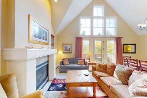 a living room with a couch and a fireplace at Castle Hill Condos O2 in Proctorsville