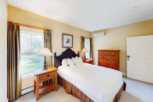 a bedroom with a large bed and a window at Castle Hill Condos O2 in Proctorsville +50 photos