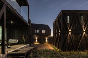 a house with a wooden fence and a patio at Qbos Matanzas in Matanzas