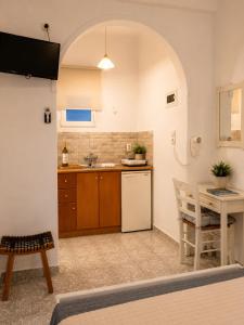 eine Küche mit einem Tisch und einem weißen Kühlschrank in der Unterkunft Alexandra Studios in Stafylos + 38 Fotos
