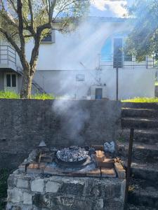 a fire pit with smoke in front of a building at Elan apartmani in Bar