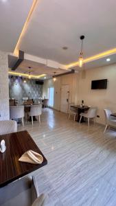 a dining room with a table and chairs in a room at MayFair Hotel Maitama Abuja in Abuja