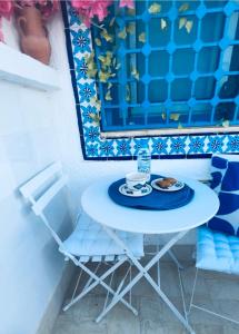 a blue and white table with a plate of food on it at Hammamet Studio Hafsya in Hammamet