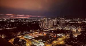 a view of a city at night with lights at Cozy private bedroom and bathroom in Surrey