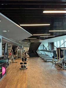 a gym with a bunch of treadmills and machines at Sheraton Apartments in Bishkek
