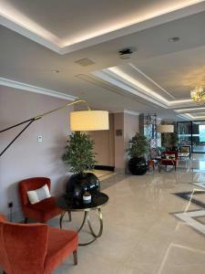 a lobby with chairs and a table in a building at Sheraton Apartments in Bishkek +35 photos