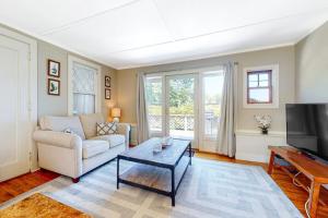 a living room with a couch and a coffee table at Black Cove Cottage in Manchester