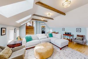 a living room with a white couch and a table at The Retreat - Suite #2 in Waterbury