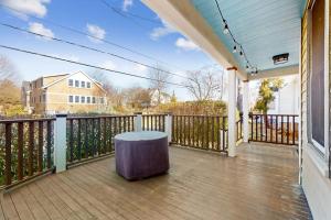a porch with a table and a fence at Gloucester Coastal Gem in Gloucester