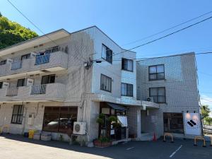 a white building with a lot of windows at STAY Moiwayama in Sapporo