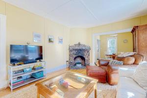 a living room with a couch and a fireplace at A Villager's Dream in North Conway