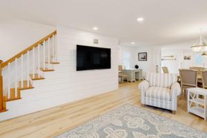 a living room with a tv on a wall at Beau in Gloucester