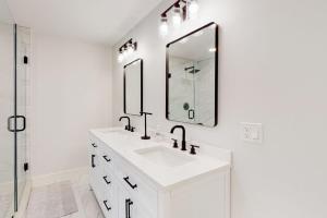 a white bathroom with a sink and a mirror at Beau in Gloucester +32 photos