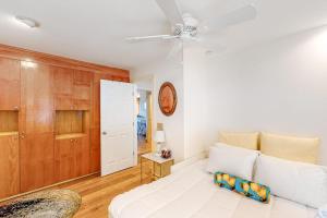 a bedroom with a white bed and a ceiling fan at Snowside 20 in Waitsfield +50 photos