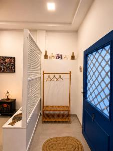 a room with a blue door and a staircase at Blueyes in Tunis