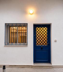 a blue door and a window on a building at Blueyes in Tunis