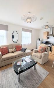 a living room with two couches and a coffee table at CJ Maison - "Spacious Family Friendly 2-Bedroom Apartment in the City Centre with free on-site parking, free Wi-Fi" in Southampton