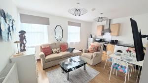 a living room with a couch and a table at CJ Maison - "Spacious Family Friendly 2-Bedroom Apartment in the City Centre with free on-site parking, free Wi-Fi" in Southampton