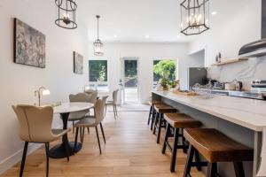 a kitchen with a long counter and a table and chairs at Shambhala Retreat-Zen Suite in Nanoose Bay