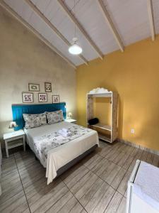 a bedroom with a large bed and a mirror at Pousada Anturio Centro in Barra Velha