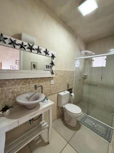 a bathroom with a sink and a toilet and a shower at Pousada Anturio Centro in Barra Velha +44 photos