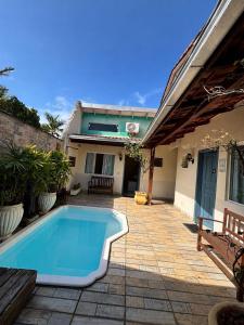 a swimming pool in the backyard of a house at Pousada Anturio Centro in Barra Velha