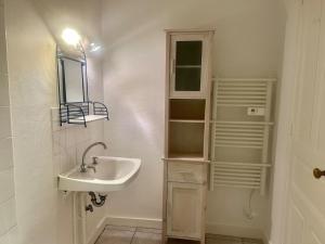 a bathroom with a sink and a mirror at Studio -Center - Lorient in Lorient