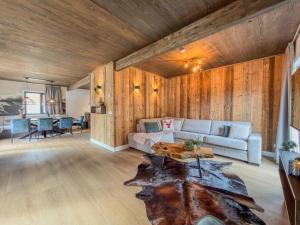 a living room with a couch and a table at Nockberge in Afritz