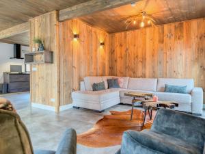 a living room with a couch and a table at Alpenzeit Afritz am See in Afritz