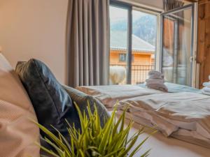 a bedroom with two beds and a large window at Alpenzeit Afritz am See in Afritz