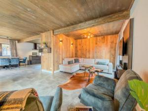 a living room with a couch and a table at Alpenzeit Afritz am See in Afritz
