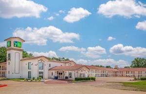 a large building with a clock tower in front of it at Extended Stay America Select Suites - Longview in Longview