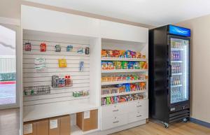 a kitchen with a refrigerator filled with lots of food at Extended Stay America Select Suites - Longview in Longview
