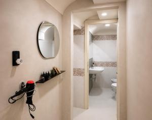 a bathroom with a toilet and a mirror on the wall at Il Castello di Atessa in Atessa +53 photos