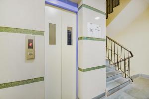 a staircase in a building with a elevator at Hotel O Tranquil Stay in Kolkata