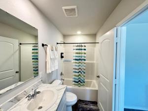 a bathroom with a sink and a toilet and a shower at Quiet at Pine Branch in Lufkin +16 photos