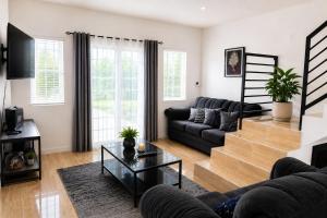 a living room with a couch and a table at Glenmuir La Ville - Gated Com May Pen in May Pen