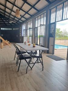 a table and chairs in a room with a pool at Maison 3 chambres in Granada