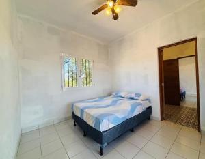 a bedroom with a bed and a ceiling fan at Maison 3 chambres in Granada
