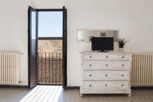 a bedroom with a dresser with a television on it at Il Castello di Atessa in Atessa