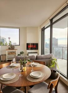 a living room with a table with plates and wine glasses at The Alpine City Escape in Calgary