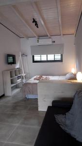a bedroom with a large bed and a window at Trovare un Senso in Capilla del Monte