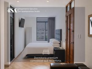 a bedroom with a white bed and a window at 4StudioAparts RC 01 in Cajamarca