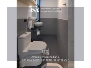 a bathroom with a white toilet and a sink at 4StudioAparts RC 01 in Cajamarca +11 photos