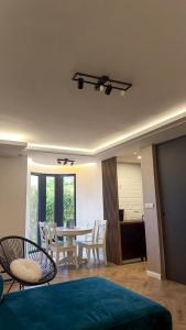 a living room with a dining room table and chairs at Villa NOA in Bijeljina